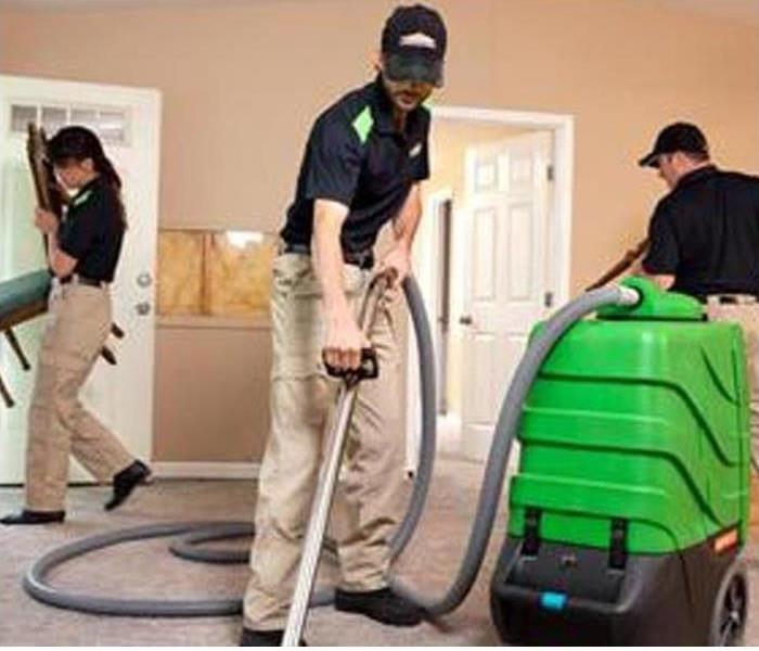 SERVPRO Crew cleaning carpet in a house